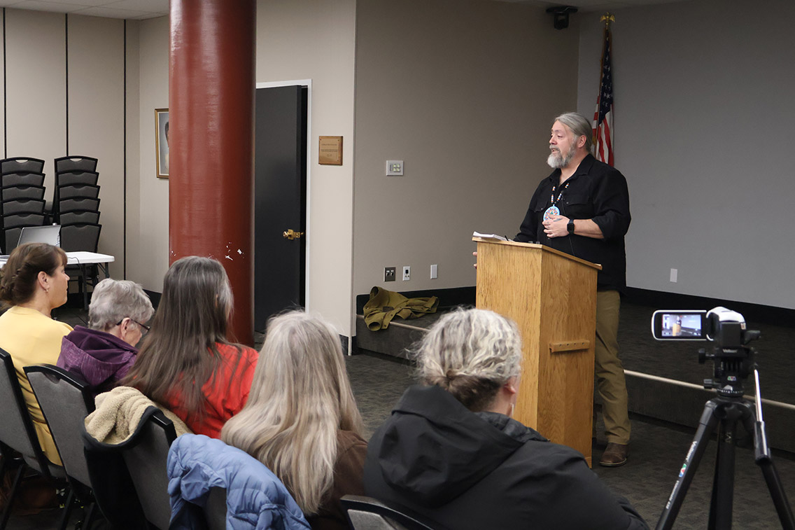 Crowd watches Poet Laureate Chris LaTray at Winter Speaker Series talk