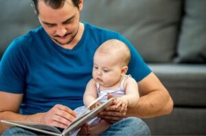 Man and baby reading a book together