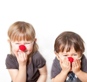 Two kids with fake red noses on