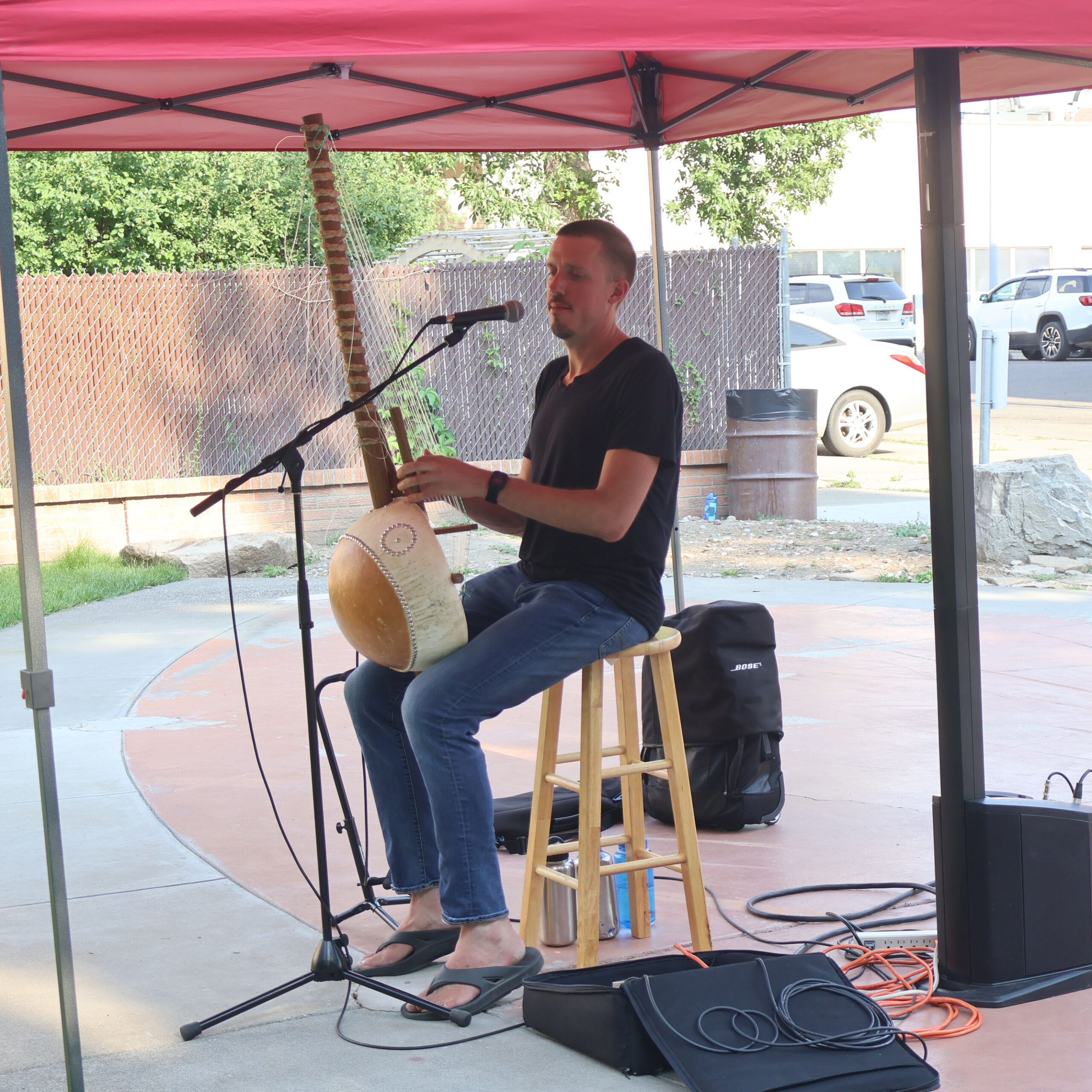 Gaskell 1 Shawn Gaskell performs his kora under a red tent in Library Park. Sean returns to the Library on June 2.